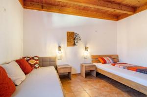 a room with two beds and a couch at Obstgut Mit Herz Thomas Maier in Stockach