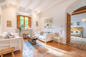 a living room with white furniture and a table at Casa Amber in Sóller +21 photos