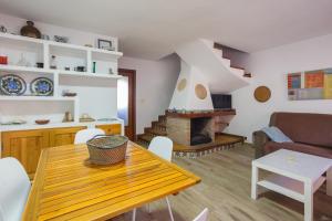 a living room with a table and a fireplace at Adosado Mareny Blau in Mareny Blau