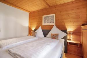 a bedroom with two beds in a wooden room at Ferienwohnung Schliersee in Schliersee