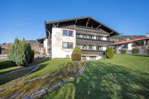 a large house on a grassy field in front at Ferienwohnung Schliersee in Schliersee