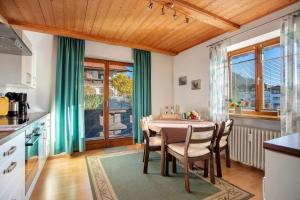 a kitchen and dining room with a table and chairs at Ferienwohnung Schliersee in Schliersee