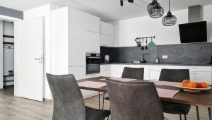 a kitchen with a wooden table and chairs at Rehkitz in Baiersbronn +24 photos