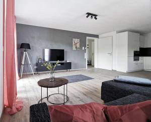 a living room with a couch and a table at Rehkitz in Baiersbronn