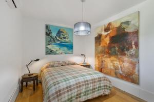 a bedroom with a bed and paintings on the wall at Finca El Dragonal With Private Pool in Santa Brígida +31 photos