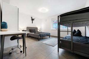 a bedroom with a bed and a desk and a bed at Gemütliche und ruhige Wohnung in Stuttgart