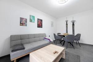 a living room with a couch and a table at Gemütliche und ruhige Wohnung in Stuttgart