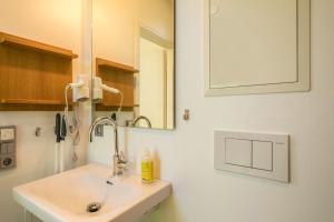 a bathroom with a sink and a mirror at Ferienhaus Falkenhalde in Deggenhausertal +22 photos