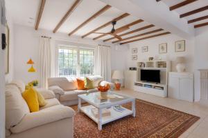 a living room with a couch and a table at Casa Can Mussenya in Illes Balears