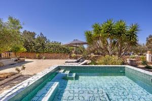 a swimming pool in a yard with trees at Casa Can Mussenya in Illes Balears