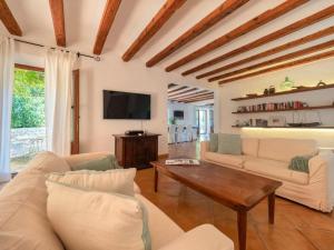 a living room with a couch and a table at Sa Cala in Deia