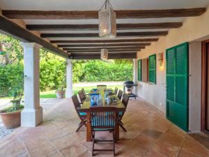 a dining room with a table and chairs on a patio at Sa Cala in Deia