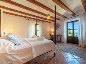 a bedroom with a bed and a large window at Sa Cala in Deia +34 photos