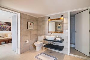 a bathroom with a toilet and a sink and a mirror at Apartment Mel de Flor in Loulé +10 photos