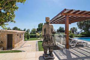 a statue of a man on a skateboard next to a pool at Apartment Mel de Flor in Loulé