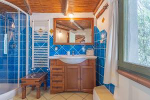 a bathroom with a sink and a mirror at Casa Penthouse in Porto Rotondo +23 photos