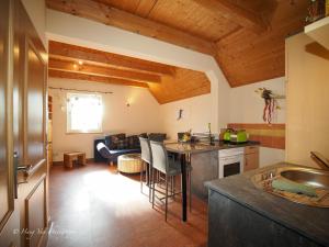 a kitchen and living room with a table and a couch at Birkenhof Pließkowitz in Malschwitz