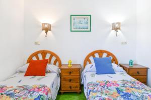two beds sitting next to each other in a bedroom at Mimosa B1 in Puerto del Carmen +12 photos