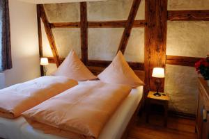 a bedroom with a bed with two pillows at Urlaub Im Kulturdenkmal in Alpirsbach