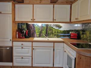 a kitchen with white cabinets and a sink at Biobetrieb Lippenhof in Breitnau +45 photos