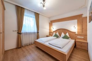 a bedroom with a bed and a window at Residence Diana Apartment 203 in Terento