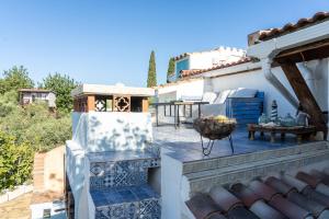 a patio of a house with a table at Habitacion Doble Jardin in Camarles