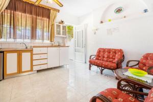 a kitchen with a table and some chairs and a counter at Panorama Tilos Apt B in Tílos