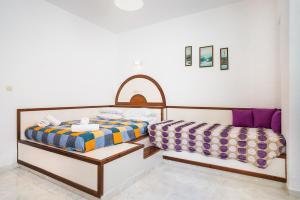 two beds sitting next to each other in a room at Panorama Tilos Apt B in Tílos