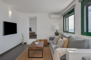 a living room with a couch and a table at Apartamentos Callao in Playa Quemada