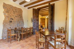 a dining room with wooden tables and chairs at Casa Vilanova in Peramea