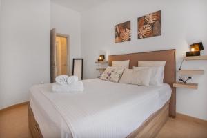 a bedroom with a large white bed with towels on it at vv Sueño Del Mar in Costa de Antigua +9 photos