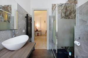 a bathroom with a white tub and a walk in shower at Vivere Lerici con parcheggio in Lerici +18 photos