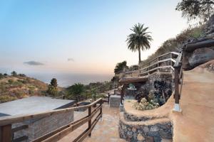 a building on a hill with a view of the ocean at Cueva El Desvelo in Tijarafe