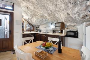 a kitchen with a wooden table with fruit on it at Cueva El Desvelo in Tijarafe