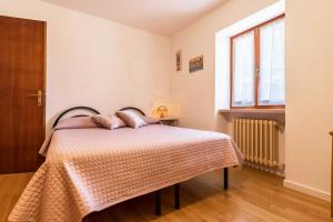 a bedroom with a bed and a window at Lola Home Brenzone in Brenzone sul Garda +21 photos