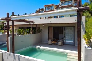 a house with a swimming pool in front of it at Studio Yvonne in Meganisi