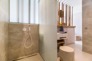 a bathroom with a shower and a stool at Studio Yvonne in Meganisi