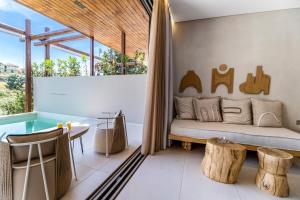 a bedroom with a bed and a table and a tub at Studio Yvonne in Meganisi