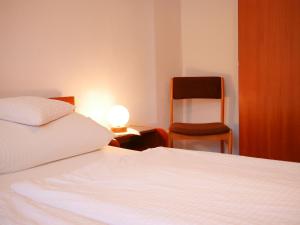 a bedroom with a bed and a chair and a lamp at Börsighof in Seebach