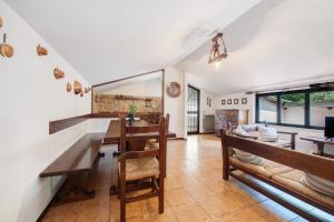 a kitchen and dining room with a table and chairs at Appartamento Rupestre 2.0 in Manerba del Garda