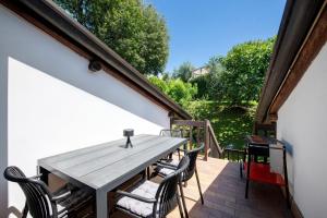 a wooden table and chairs on a patio at Appartamento Rupestre 2.0 in Manerba del Garda