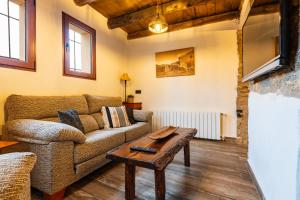 a living room with a couch and a table at Masía La Parreta in Villafranca del Cid
