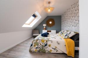 a bedroom with a bed with a yellow blanket at Ty Laouen Gite Quiberon in Quiberon