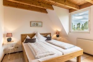 a bedroom with a large bed and a window at Appartement Böhler 2 in Reichenau