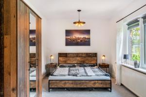 a bedroom with a bed and a painting on the wall at Ferienhaus Behrends in Emden