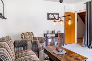 a living room with two chairs and a table at Ferienhaus Behrends in Emden