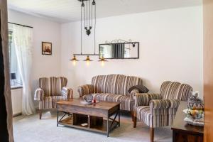 a living room with two chairs and a table at Ferienhaus Behrends in Emden