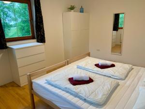 two beds in a bedroom with a mirror at Haus Auner Top 1 in Westendorf