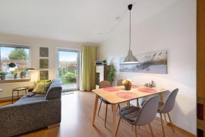 a living room with a table and a couch at Huus Meernmank in Achtrup