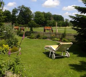 a green chair sitting in the grass in a yard at Huus Meernmank in Achtrup